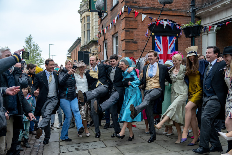 The cast of 'The Crown' dancing on set.