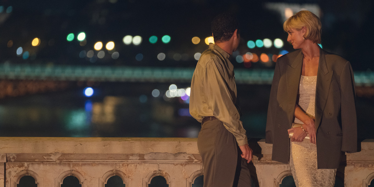 Dodi and Diana standing together on a bridge at night.