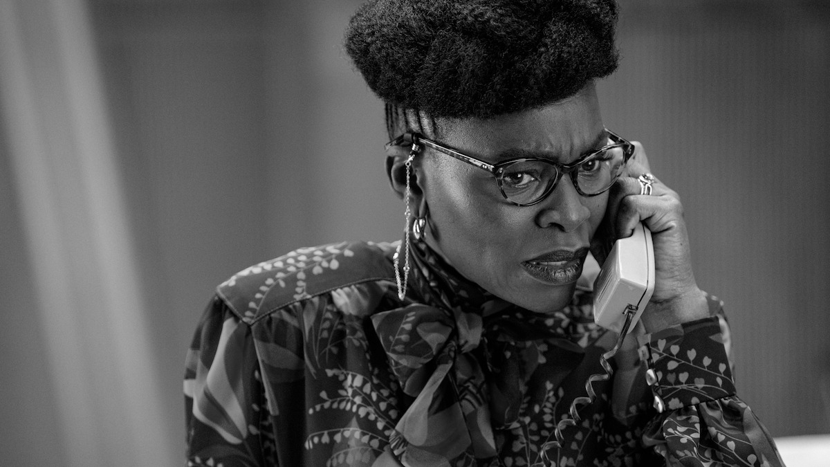 Black-and-white image of Rakie Ayola as Persephone taking a phone call in Season 1 of ‘Kaos’
