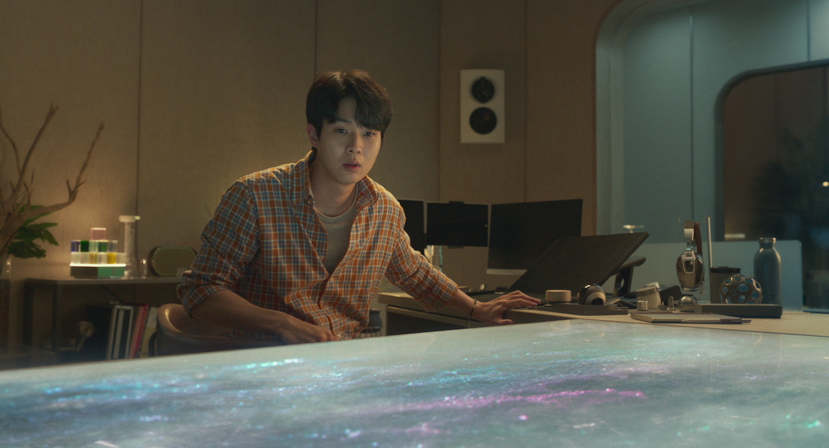 Choi Woo-shik sits at a desk looking surprised in an image from the film ‘Wonderland’