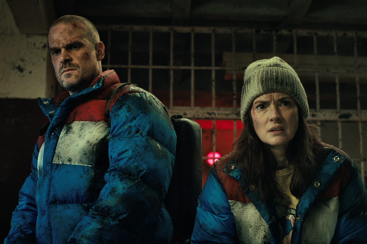  A man and woman wearing winter clothing, with bruises on their concerned faces.