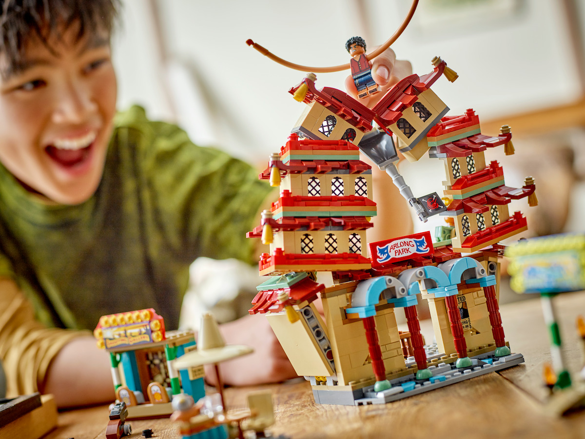 A boy plays with the Battle at Arlong Park toy from the 'ONE PIECE' LEGO Collaboration