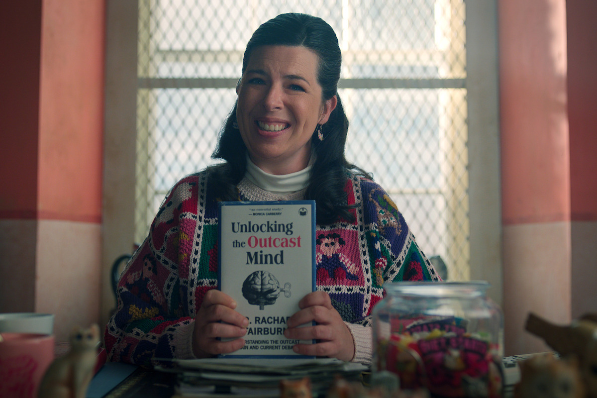 Heather Matarazzo as Judi Spannegel smiles at her office desk in ‘Wednesday’ Season 2.