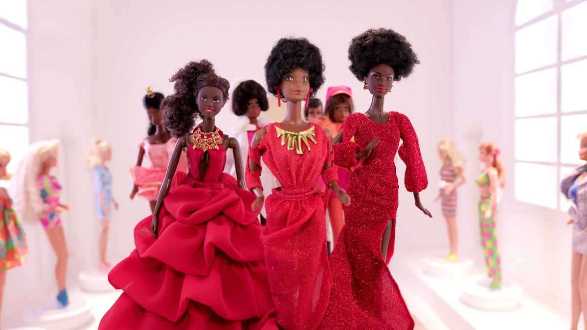 Several posed Black Barbie dolls.
