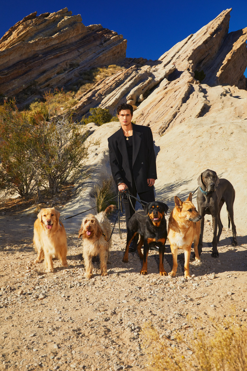 Charles Melton poses with dogs.