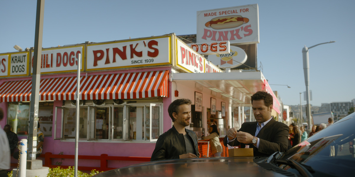 Mickey Haller (Manuel Garcia-Rulfo) chows at Pink’s Hot Dogs with his client Trevor Elliott (Christopher Gorham).
