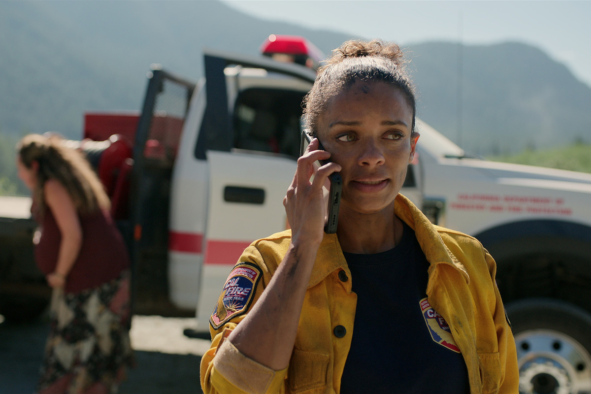 Kandyse McClure as Kaia wears a firefighter’s uniform and takes a phone call in in Season 5 of ‘Virgin River.’