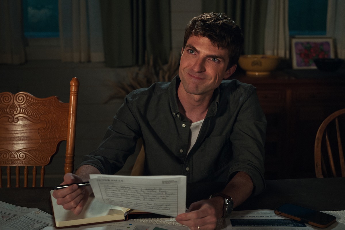 Johnny Link as Will sits at a table in ‘My Life with the Walter Boys’ Season 2.