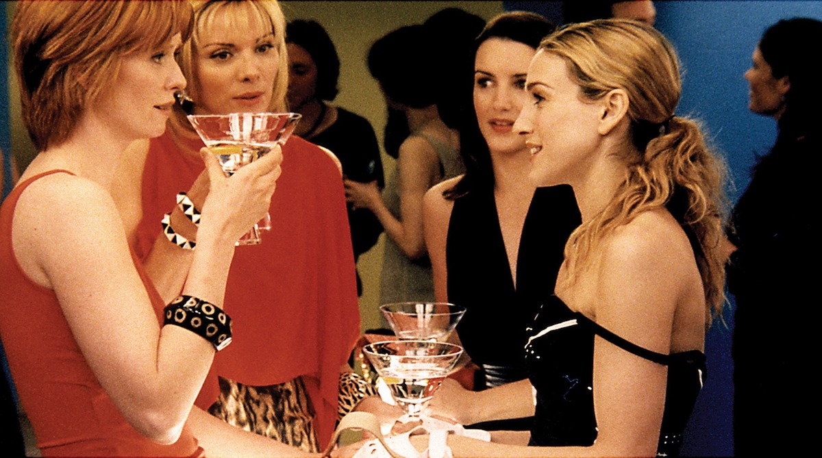 Miranda (Cynthia Nixon), Samantha (Kim Cattrall), Charlotte (Kristin Davis), and Carrie (Sarah Jessica Parker) gossip over drinks in ‘Sex and the City’ Season 4.