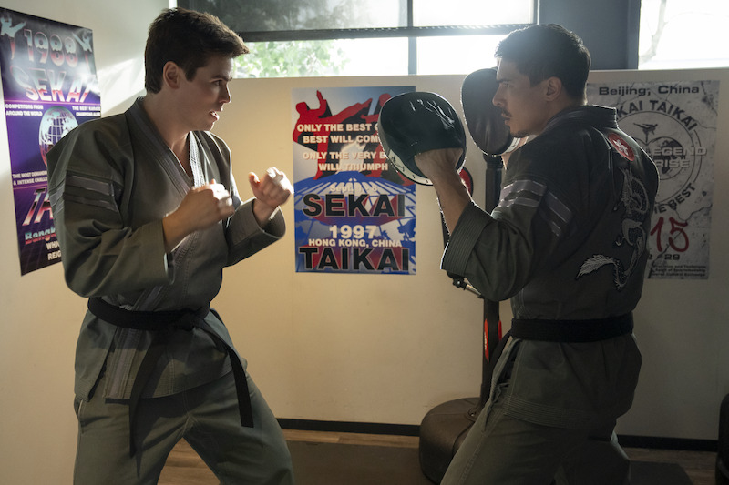 Patrick Luwis as Axel and Lewis Tan as Sensei Wolf train together in Season 6, Part 2 of 'Cobra Kai'