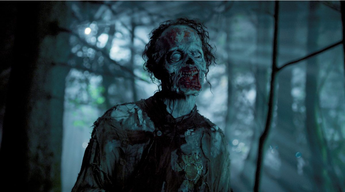 Owen Painter as Slurp in a dark forest in ‘Wednesday’ Season 2.