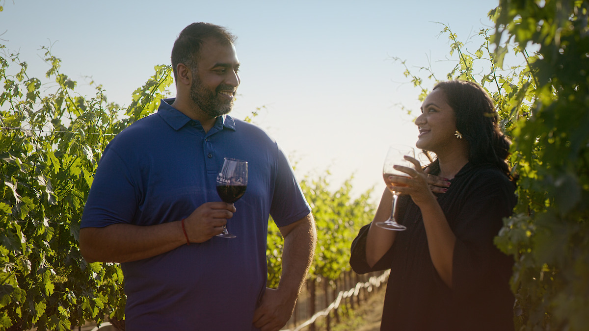 A couple sips wine on a date. 