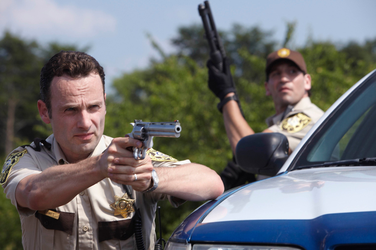 Rick aiming his gun at someone. 