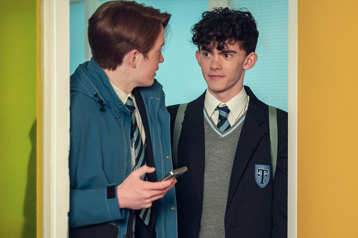  Two young men wearing school uniforms.