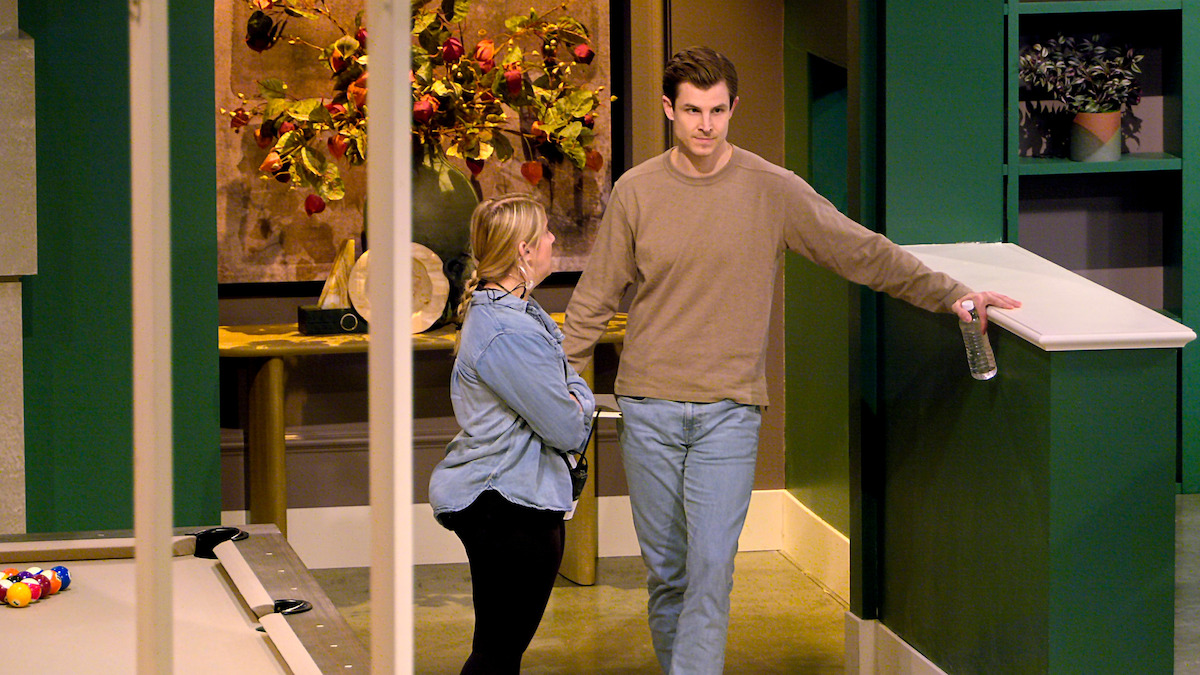 Blake speaks to a crew member about leaving.