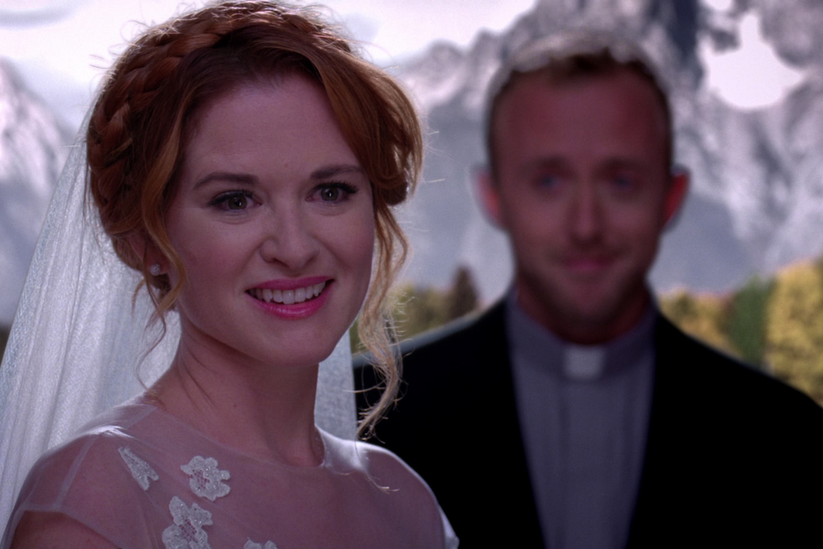 a bride looks happy on her wedding day at the altar. 