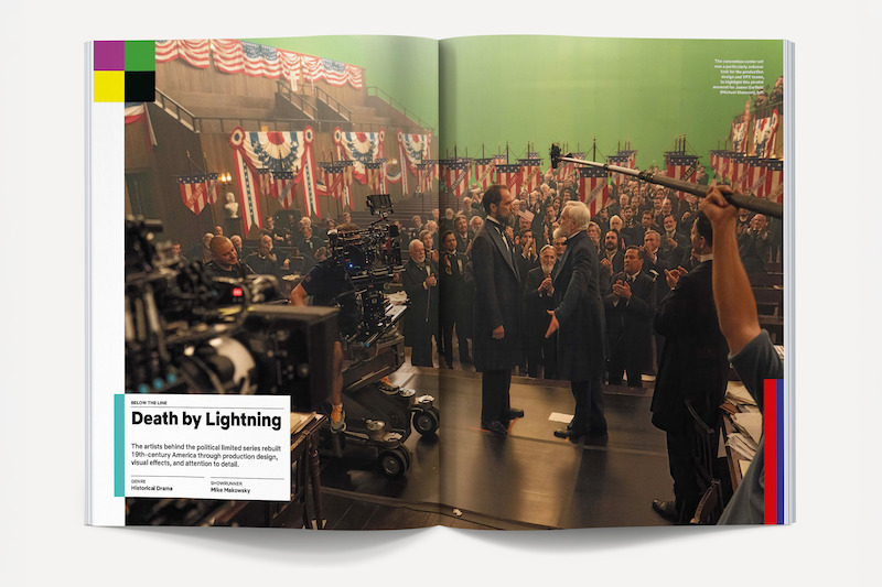 Film crew shoots a political drama scene in a decorated hall with actors on a stage, cameras, boom mics, and green screen background; large American flags and people in formal attire fill the set.