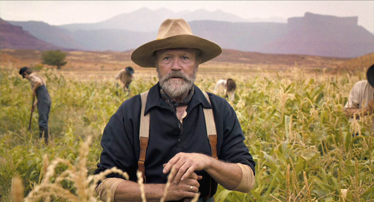 A man in a cowboy hat stands in a wheat field in ‘Horizon: An American Saga: Chapter 1’