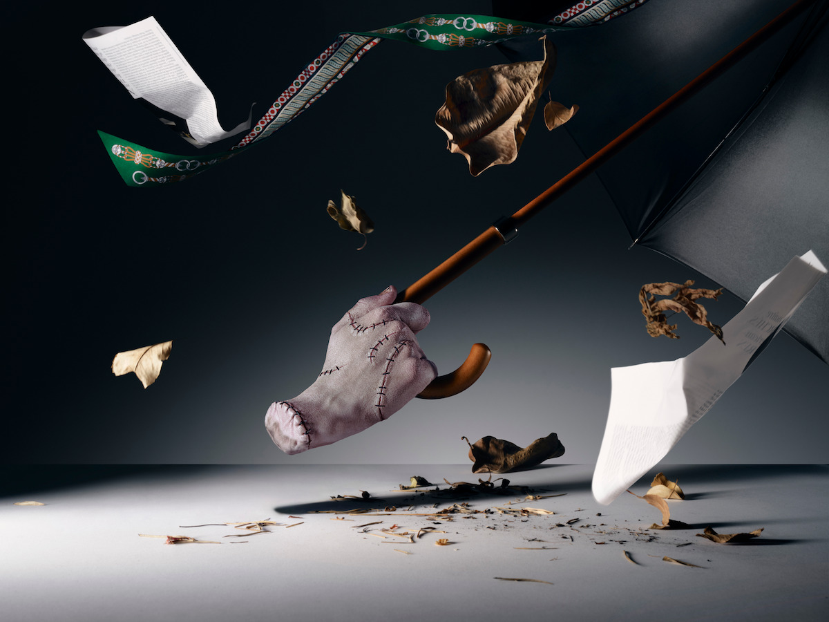 Thing holding a flying umbrella in a windy space.