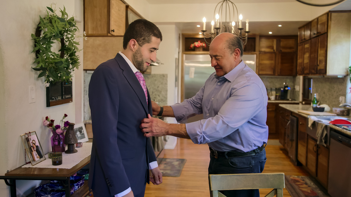 Adan’s father adjusting his suit