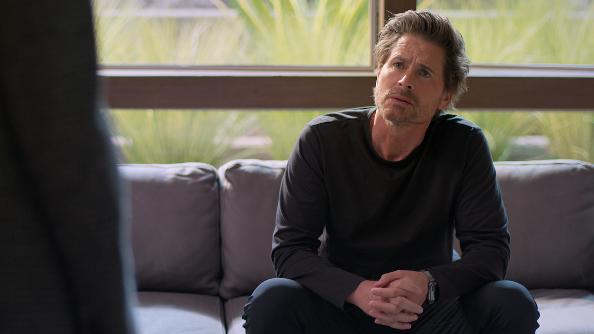 Rob Lowe sits on a couch in Season 2 of 'Unstable'