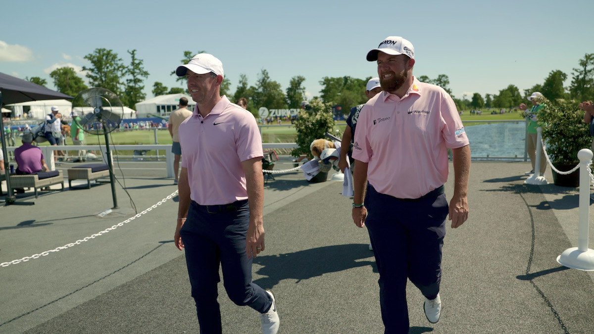 Rory McIlroy and Shane Lowry walk side by side.