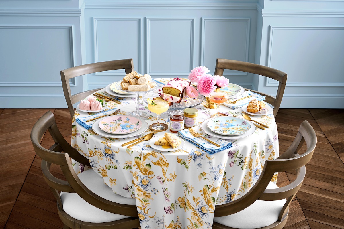 A table for four set with pastel plates and flowers featuring items from the ‘Bridgerton’ collaboration with Williams Sonoma