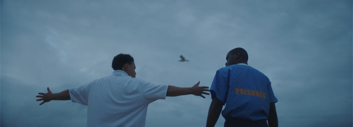 Two young men look at the sky