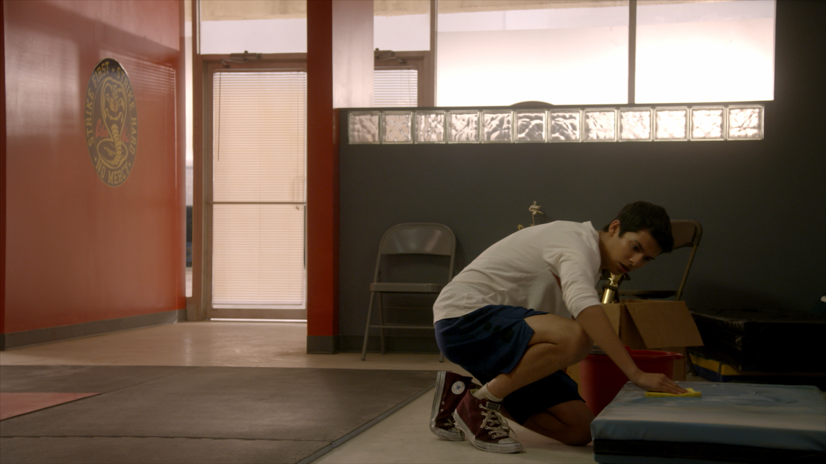 Miguel cleans the dojo floor