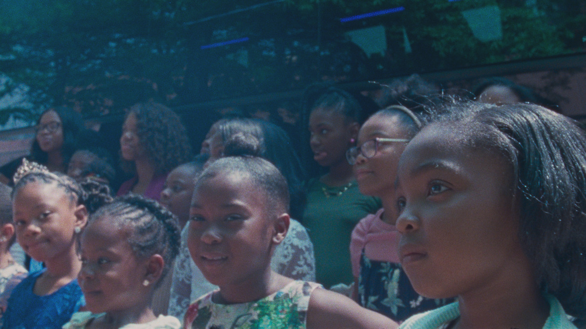 Aubrey Smith stands with some other young girls in the sun.