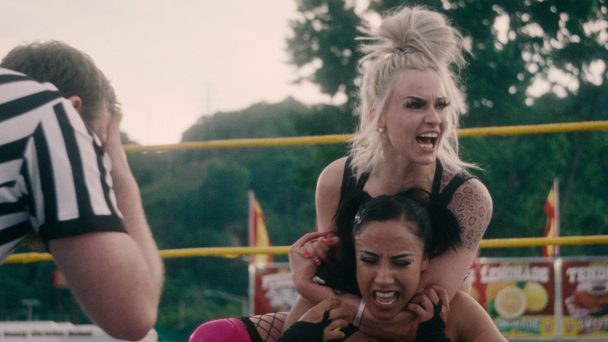  Hollyhood Haley J holds a wrestler in a headlock in Wrestlers. 