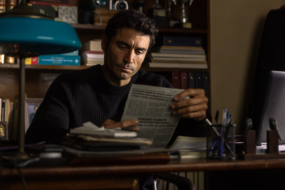 Alex García as Miguel Ferrer pours over old news articles in ‘The Crystal Cuckoo.’