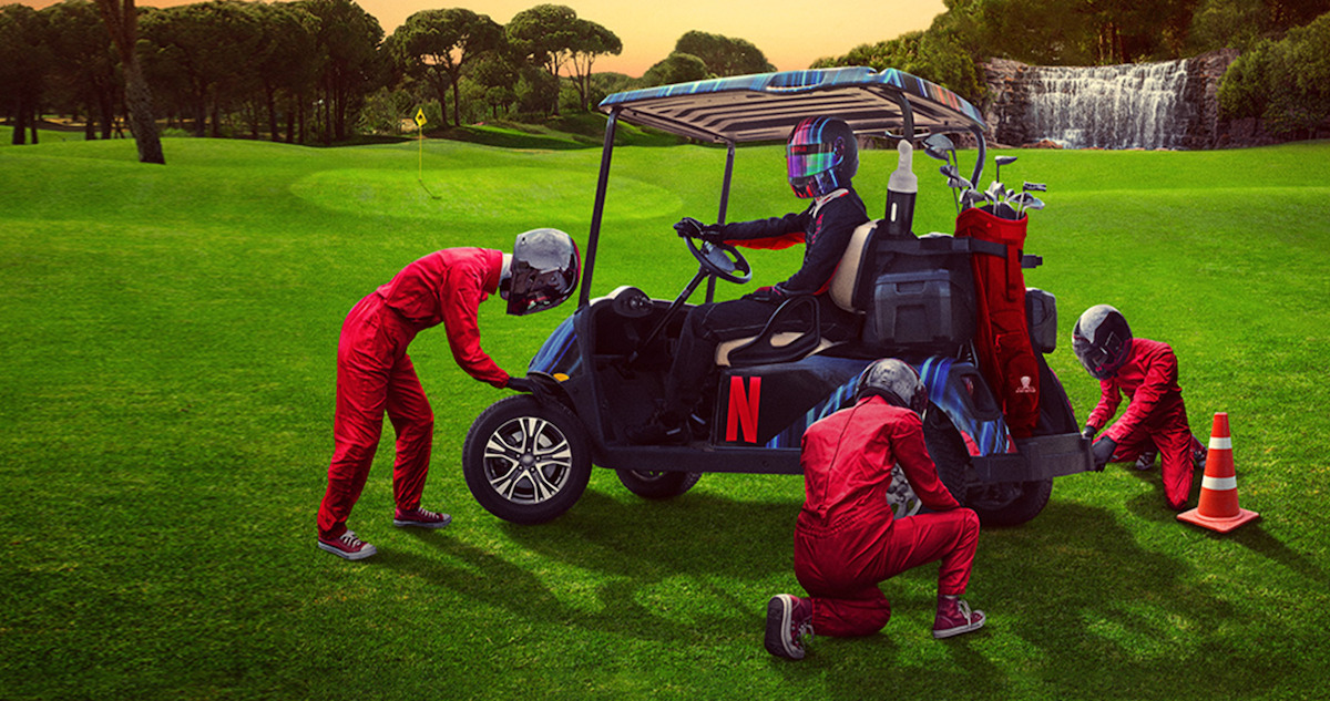 A crew works on 'The Netflix Cup' golf cart.