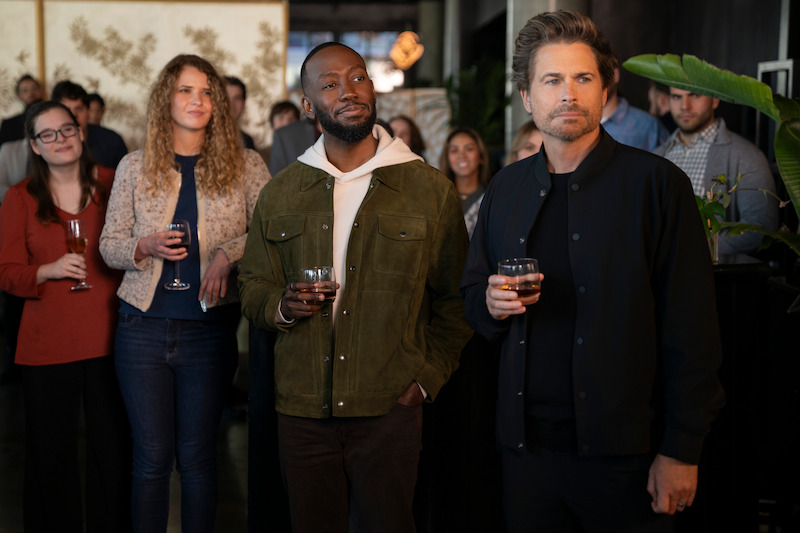 Lamorne Morris as Peter and Rob Lowe as Ellis stand at a party holding drinks in Season 2 of 'Unstable'