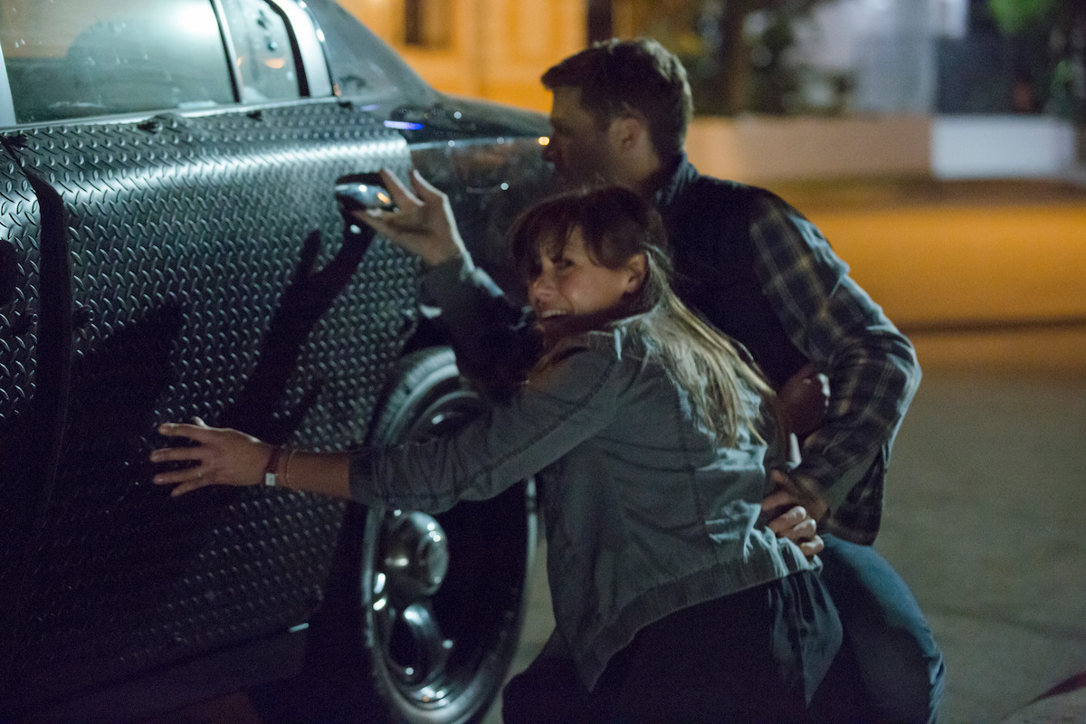 Zach Gilford as Shane and Kiele Sanchez as Liz hide in an unlocked car in ‘The Purge: Anarchy.’