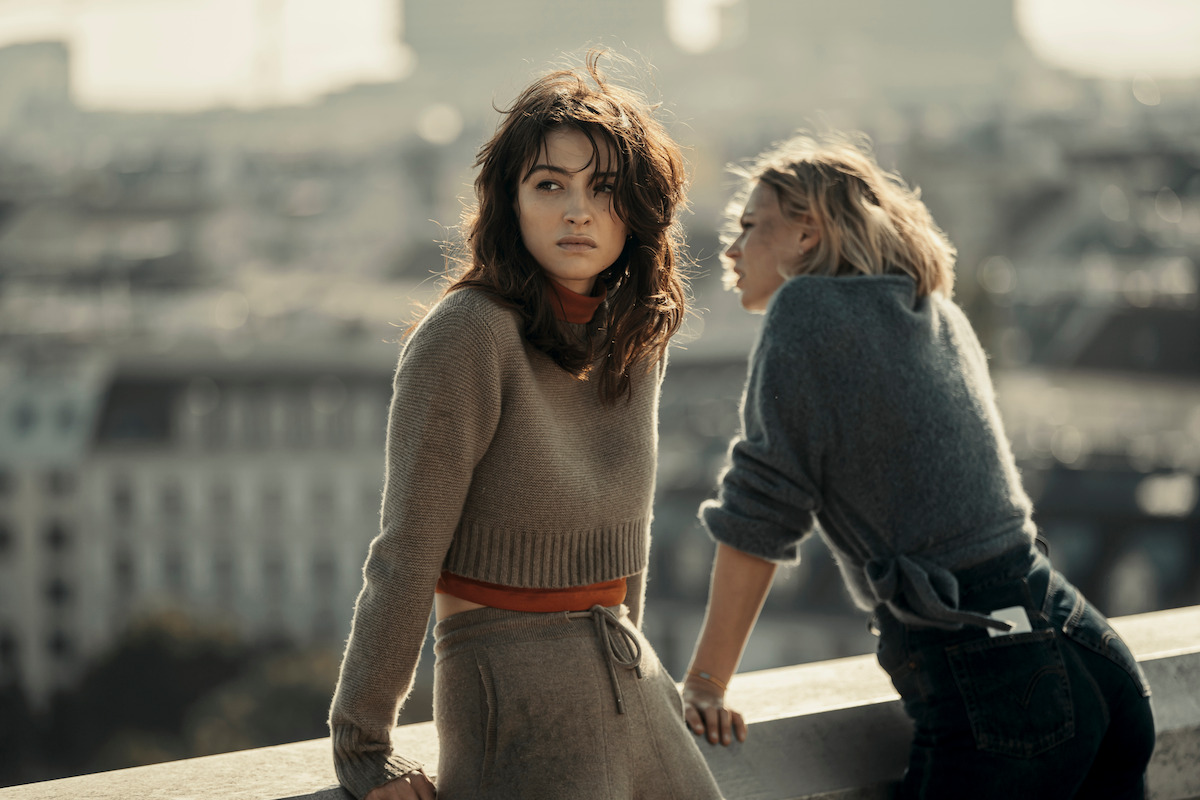 Lera Abova as Irina and Jeanne Goursand as Sara Wulf lean against a concrete railing on a roof in an image from ‘Exterritorial.’