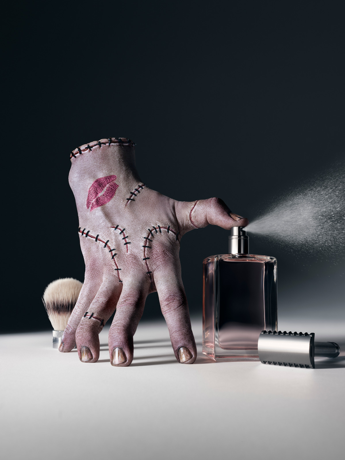 Thing spraying a perfume bottle.