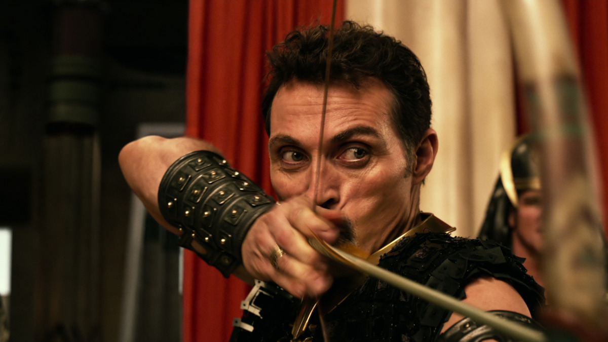 Rufus Sewell as Urshu shoots an arrow in a production still from ‘Gods of Egypt.’