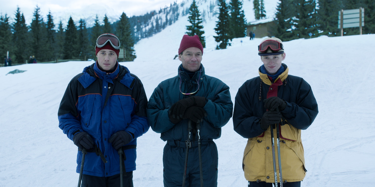 Prince William, Prince Charles and Prince Harry standing on a mountain in snow suits in ‘The Crown.’