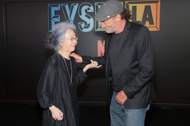 Two peopel exchange conversation in front of a backdrop that says FYSEE.