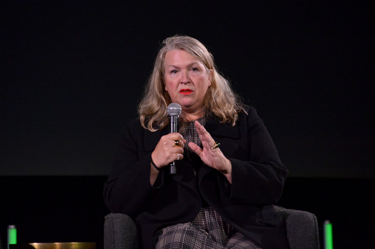 Kate Hawley holds a microphone.