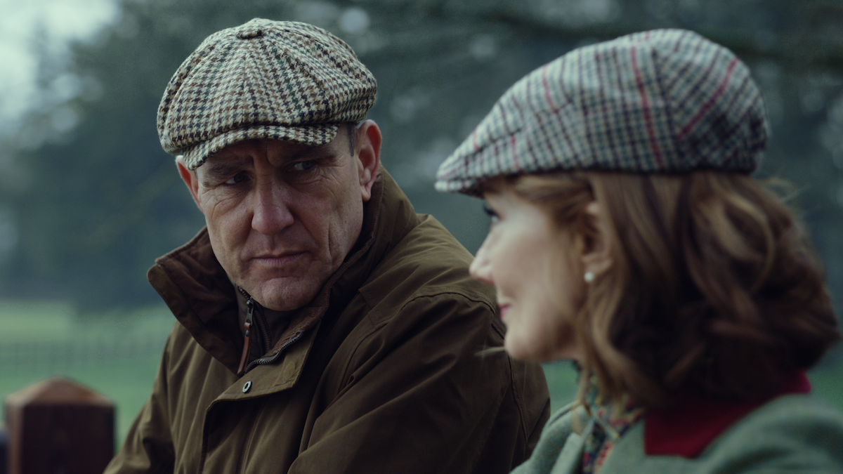 Vinnie Jones as Geoff and Joely Richardson as Lady Sabrina sit outdoors together in Season 1 of ‘The Gentlemen.’