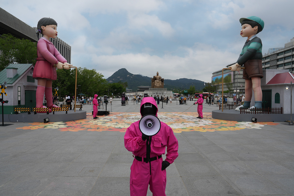Pink Guard with a megaphone at the ‘Squid Game’ Season 3 Gwanghwamun event in Seoul.