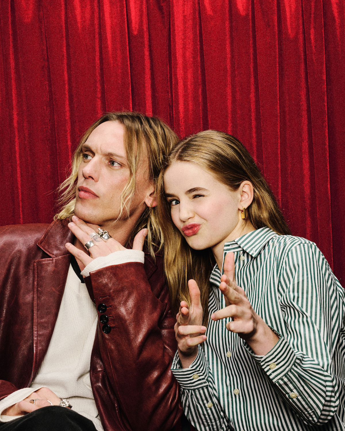 Jamie Campbell Bower and Nell Fisher pose in a photobooth.
