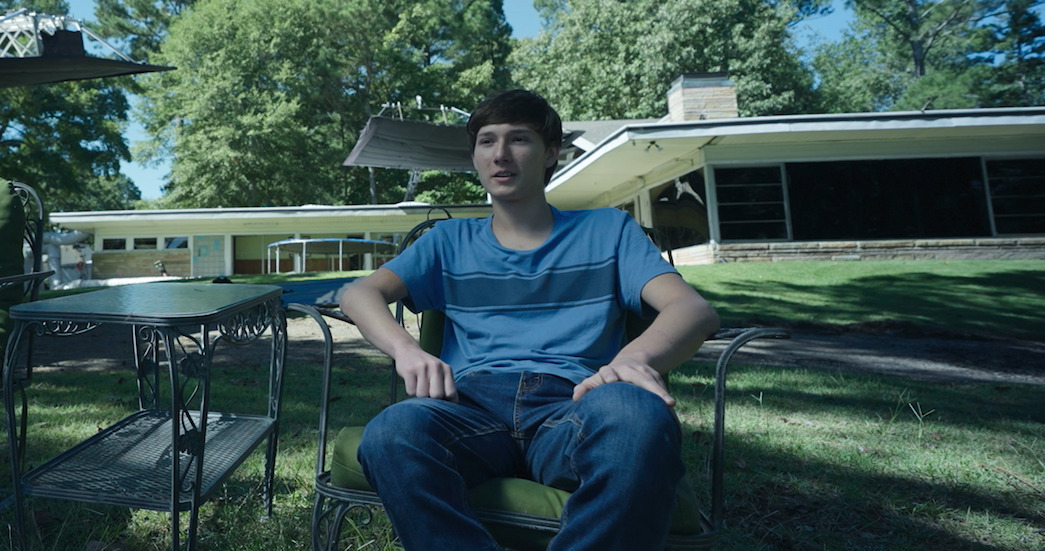 Jonah Byrde sits in front of the Byrde family home on Lake Lanier in 'Ozark'
