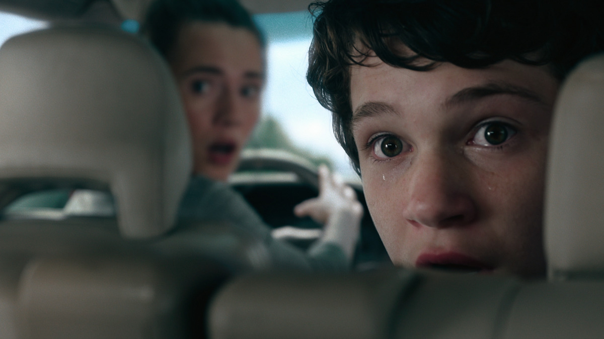 Caren Pistorius in the driver’s seat and Gabriel Batemen in the backseat of a car in ‘Unhinged’