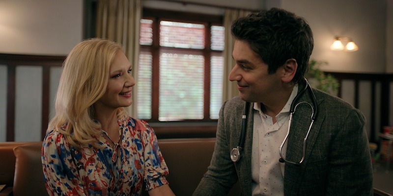 Teryl Rothery as Muriel St. Claire and Mark Ghanime as Dr. Cameron Hayek sit together smiling in Season 5 of ‘Virgin River.’