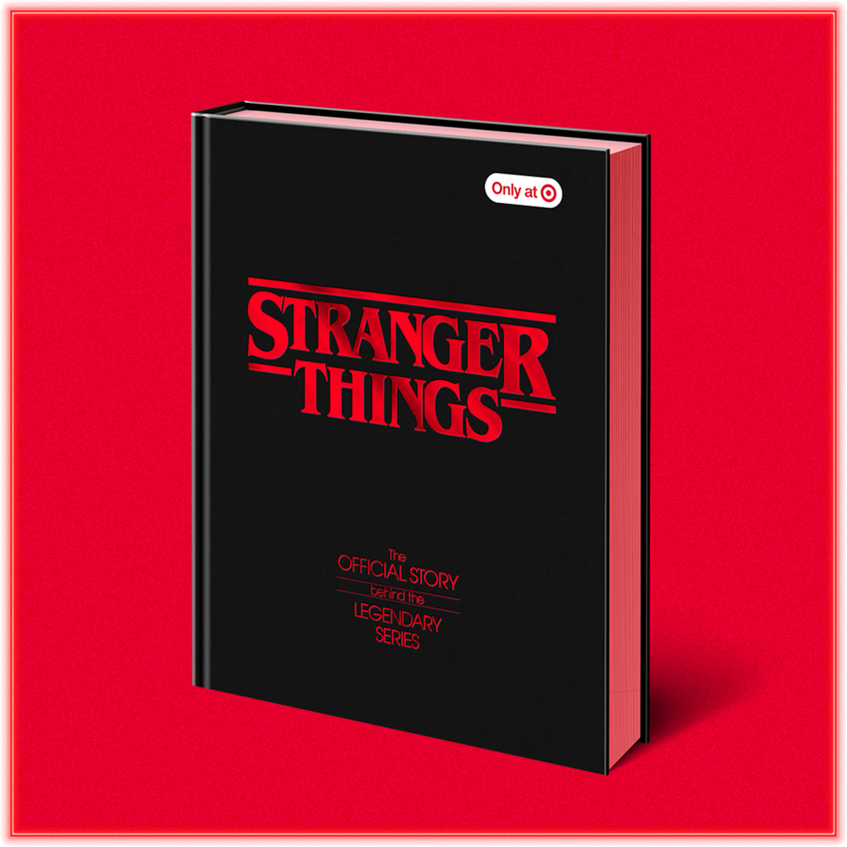 Black hardcover book titled "Stranger Things: The Official Story," displayed upright on a solid red background, with an "Only at Target" sticker on the cover.