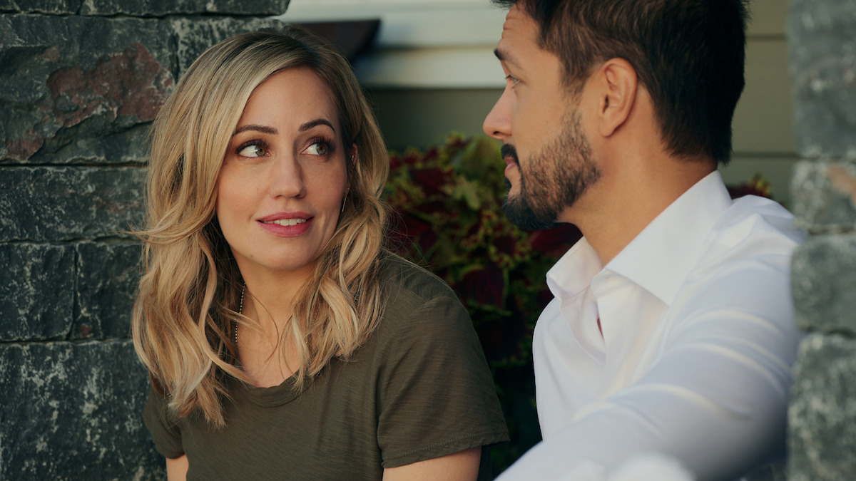 Zibby Allen (as Brie) and Marco Grazzini (as Mike) sit and face each other conversing in Season 5 of ‘Virgin River.’