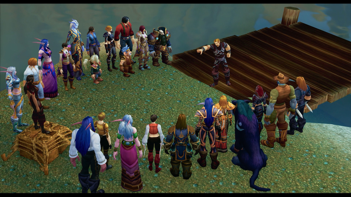 Ibelin’s friends gather around him in World of Warcraft. There are upwards of 20 characters, in a range of outfits, standing on a grassy lawn.